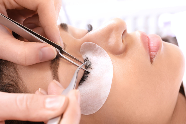 Customer receiving eyelash extensions from a skilled technician